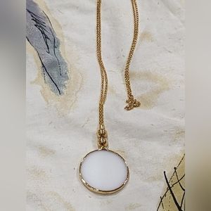 Beautiful gold tone drop necklace with white glass circle pendant. 17.5" drop